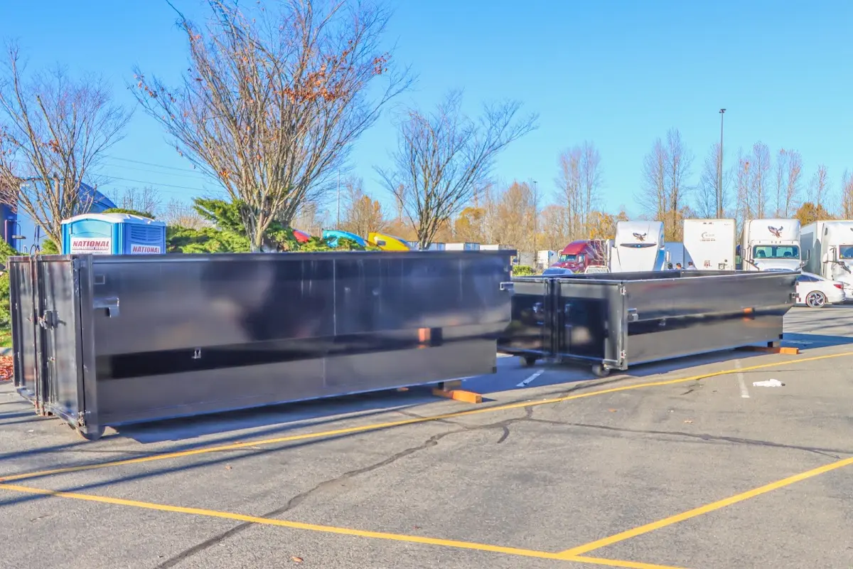 Professional dumpster rental service with roll-off container on residential driveway in Lake Alfred